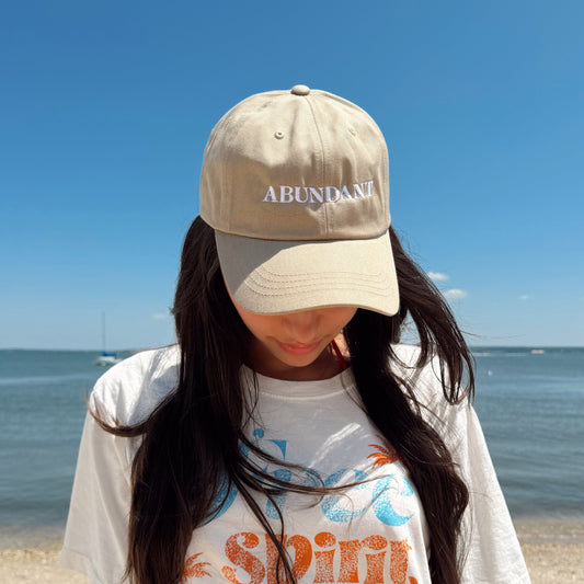 Person wearing a cap and t-shirt with text on a beach